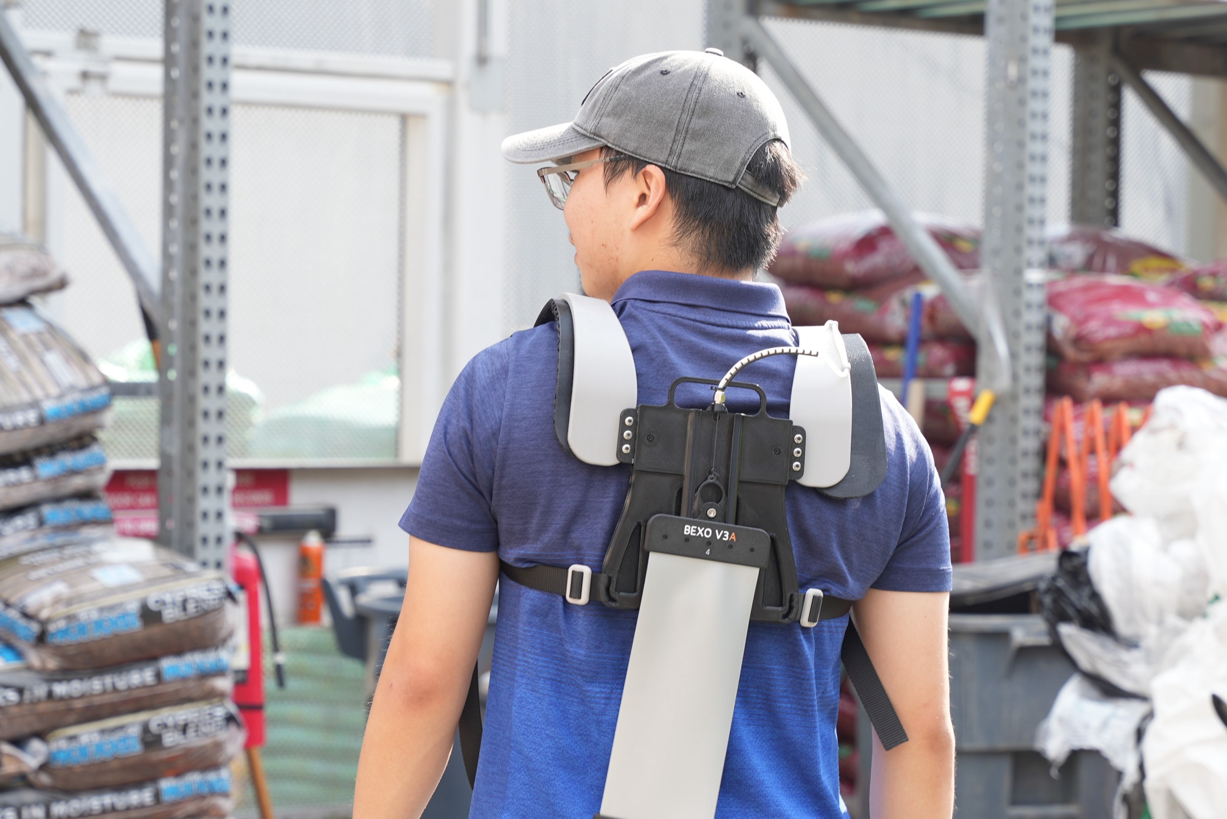 Worker wearing the Bexo back exosuit in a warehouse